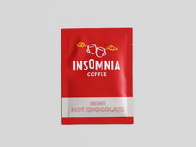 Load image into Gallery viewer, A red stand-up pouch of Insomnia Coffee Instant Hot Chocolate, featuring white text and a white band at the bottom, centered on a light gray background.
