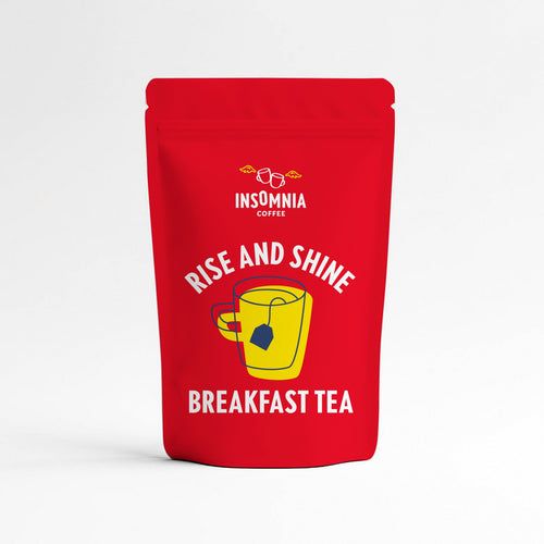 A red stand-up pouch of Insomnia Coffee Breakfast Tea with a yellow mug graphic and white text, set against a clean white background.
